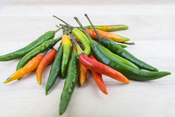 Hot Chilli Peppers isolated on wood board background, close up. Selective focus