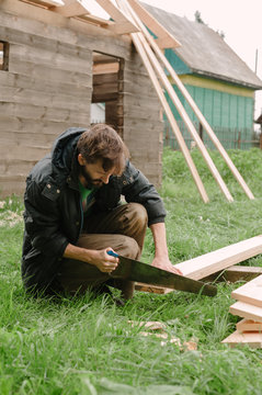 Man building wooden house