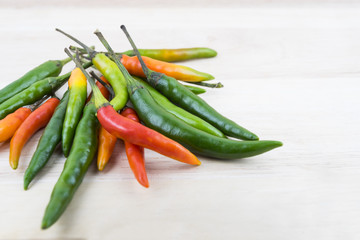 Hot Chilli Peppers isolated on wood board background, close up. Selective focus