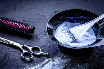 hair dye with brush on dark background