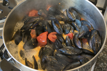 cooking mussels in a pepper broth