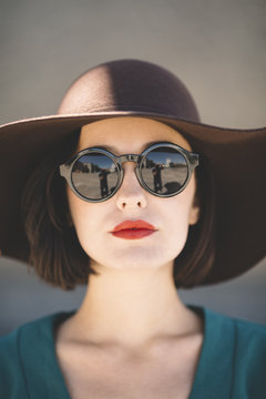 young woman wearing hat in closeup .