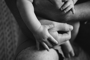 Close up of mans hands holding little baby