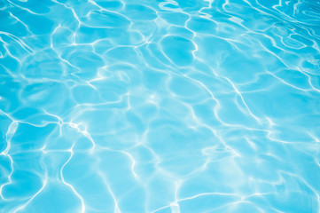 Fototapeta na wymiar Blue and bright water surface and ripple wave with sun reflection in swimming pool
