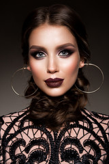 Beauty Brunette Woman with Perfect Makeup. Beautiful Professional Holiday Make-up. Red Lips,...