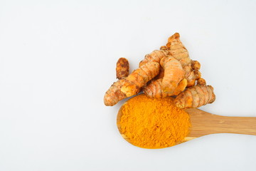 Turmeric powder and turmeric, bamboo ladle with isolated white background