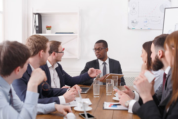 Business team meeting of young successful team with black male boss.