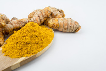 Turmeric powder and turmeric, bamboo ladle with isolated white background