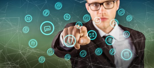 Composite image of young serious businessman pointing at camera