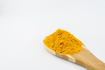 Turmeric powder and bamboo ladle with isolated white background