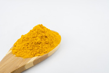 Turmeric powder and turmeric, bamboo ladle with isolated white background