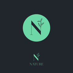 N letter.  N monogram. Nature logo for cosmetic or organic food. Green letter with leaves on a dark background.