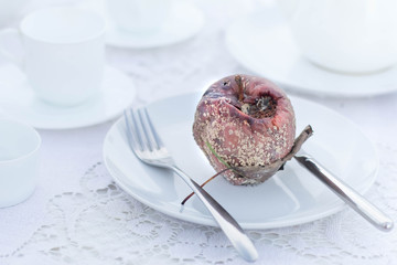 Halloween Vampire Dracula Dinner Scary Gothic Table Setting Food Concept. Sterility and Dirt. Rotten Apple White Plate. Disgusting Treat. Bad harvest. Useless fertilizers pesticides Insecticides.
