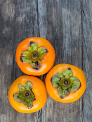 ripe persimmon on wooden background