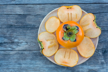 ripe persimmon on wooden background