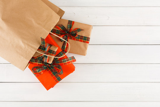 Creative Christmas Gifts In Paper Bag On White Wood Table Background