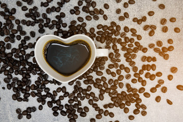 top view of coffee cup heart shape and coffee bean on concrete background