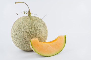 Close up view of a rock melon isolated on a white background.