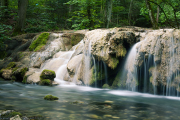 Fototapeta na wymiar Beautiful stream waterfall in the deep forest