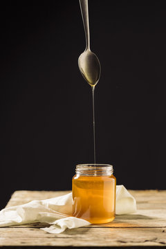 a spoon dropping honey