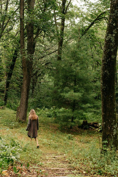 Woman walking on nature trail in a forest