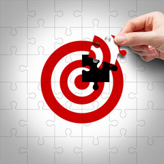 Business target concept of hand putting the jigsaw puzzle last missing piece