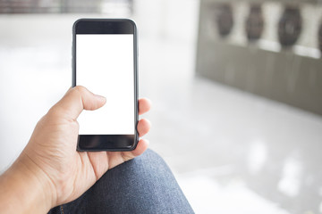Asian man holding phone on street using application playing social media check comment update status and send email isolated for insert