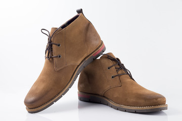 Male brown leather boot on white background, isolated product, comfortable footwear.