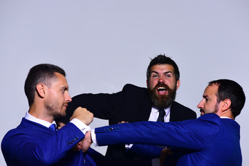 Businessmen with serious and angry faces in formal suits