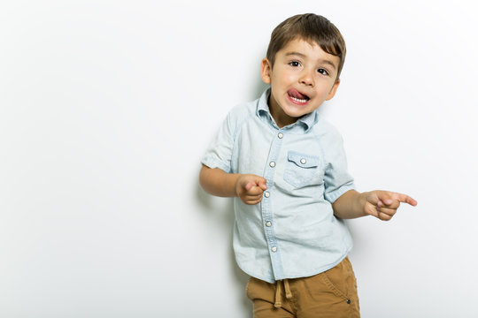 Boy having fun on studio grey background