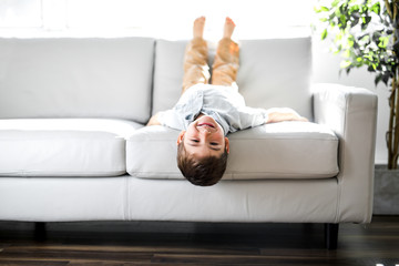 Young Boy Relaxing On Sofa At Home