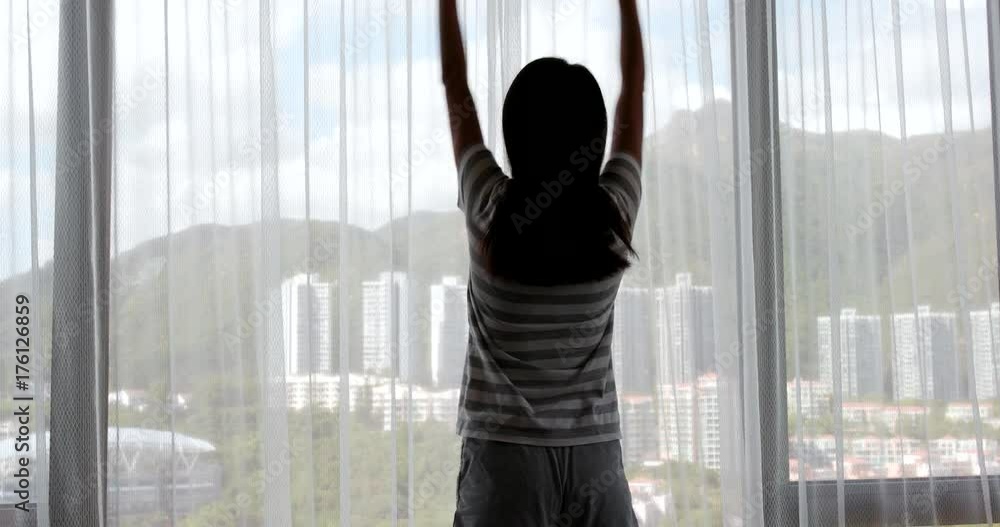 Poster woman stretching arm and open window curtain