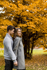 Lovely young couple in the autumn forest