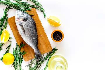 Fresh dorado fish ready to cook on white background top view copyspave