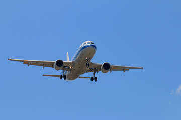 Passenger Airplane Taking Off Into The Blue Sky