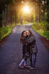 Young girls hugs in a sunny autumn day