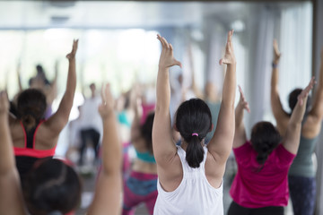 Women asian exercising in fitness studio yoga classes