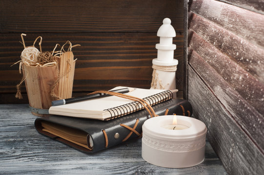 Open notepad, candle, pencil and decor