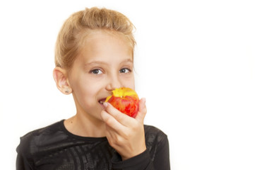 The girl eats peach and smiles. Portrait of a white background