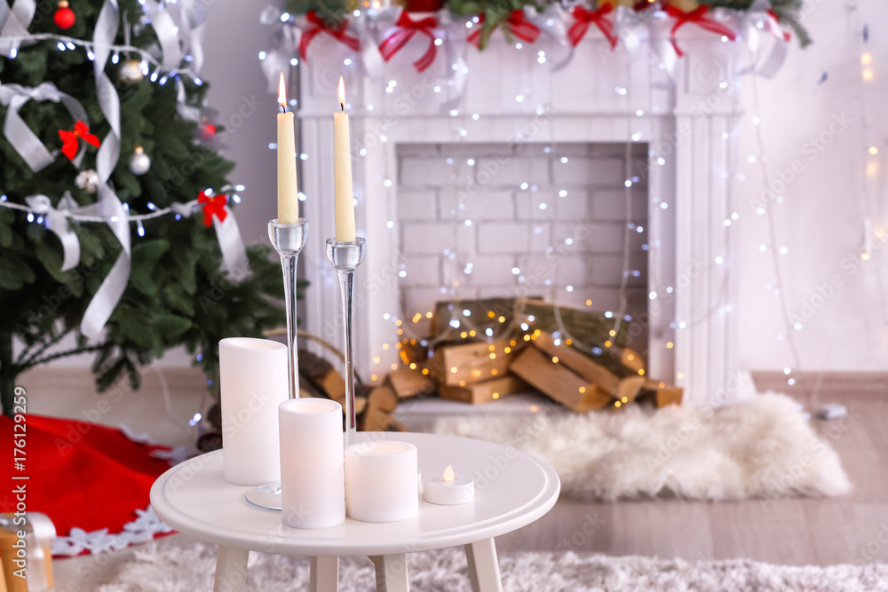 Wall mural Table with candles in room decorated for Christmas