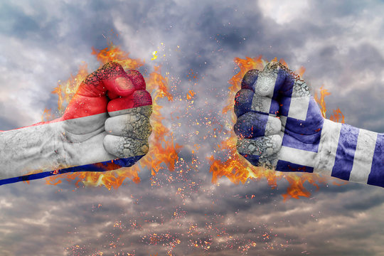 Two fist with the flag of France and Greece each other ready for fight