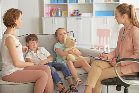 Young child psychologist working with family in office