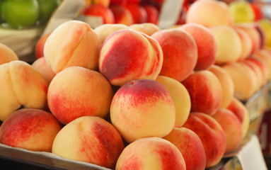 Delicious peaches on counter at market, closeup