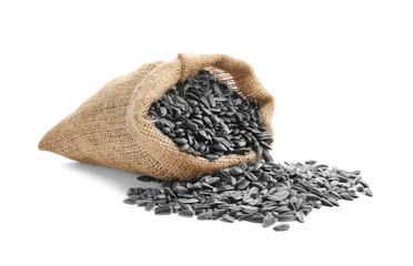 Bag with sunflower seeds on white background
