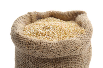 Bag with quinoa on white background, closeup