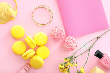 Composition with notebook, macarons and accessories on color background. Beauty blogger concept