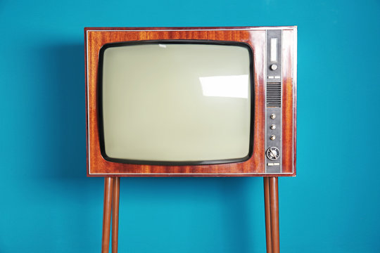 Old TV on color background