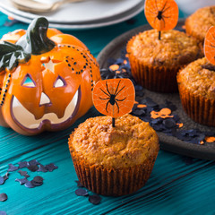 Pumpkin muffins with chocolate chips for Halloween kids party. Holiday decorations