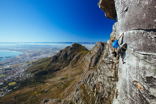 Rock climber on a sheer cliff face