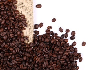 Pile coffee beans on jute, linen sack isolated on white background, top view
